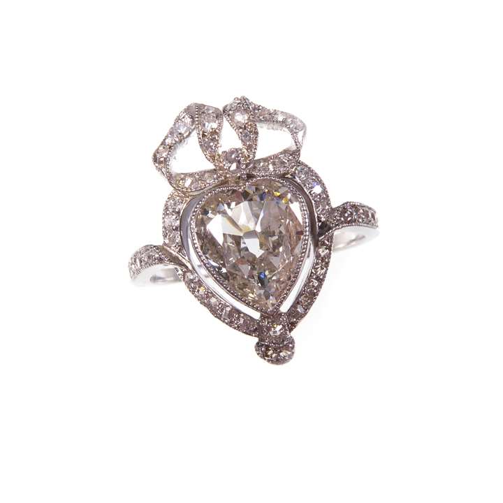 Heart shaped diamond cluster ring with ribbon bow surmount
